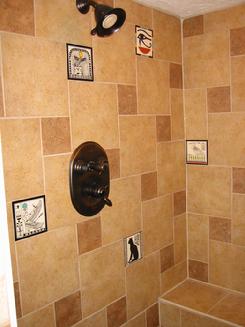 Hand Painted Besheer Art Tile with Egyptian Designs Installed in a Bathroom Shower